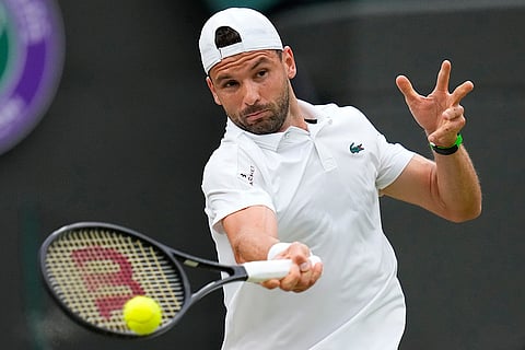 Grigor Dimitrov plays a forehand return to Daniil Medvedev